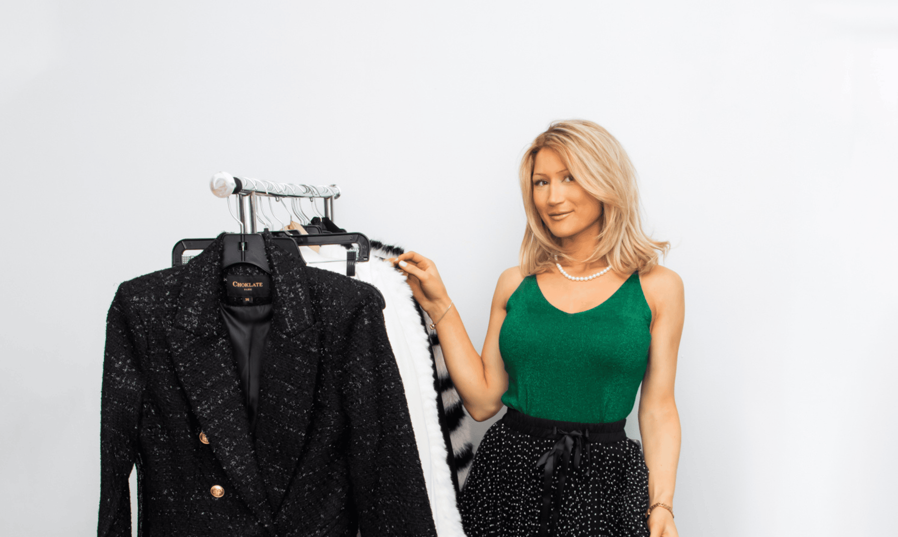 Elagant clothes on a rack with a model near by